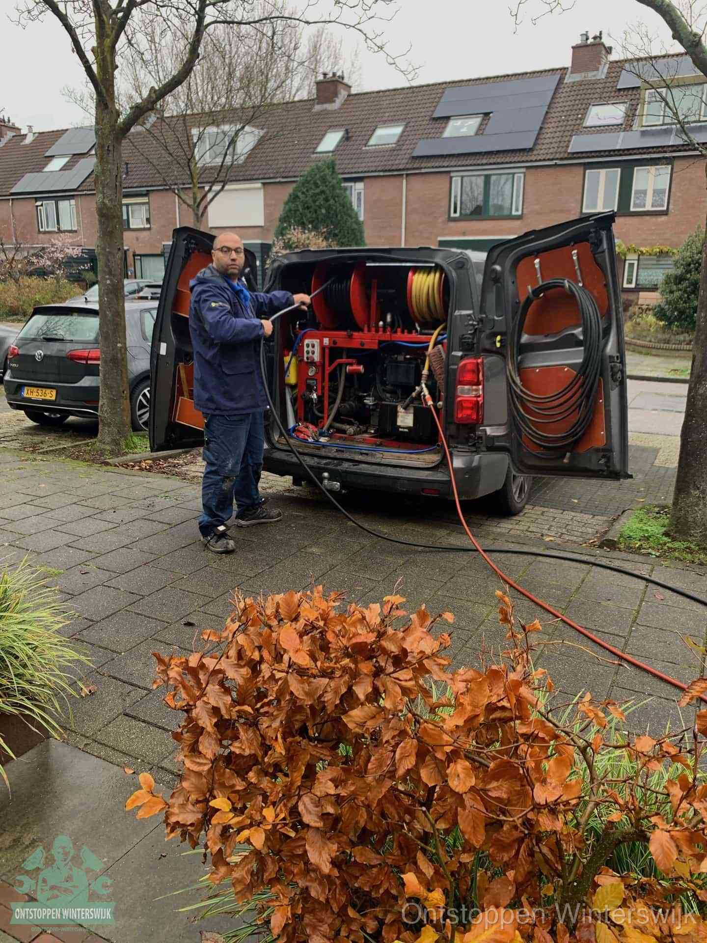 Een monteur staat bij zijn open bestelbus met hogedruk-rioolreinigingsapparatuur, klaar om binnen 30 minuten uit te rukken voor een spoedverstopping in Winterswijk